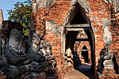 Ayutthaya, Thailand. Wat Chaiwatthanaram, the sitting Buddha statues aligned along the gallery have not survived, today only some headless pieces of the statues remain. 